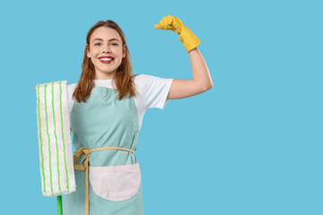 Pretty woman with mop flexing on blue background