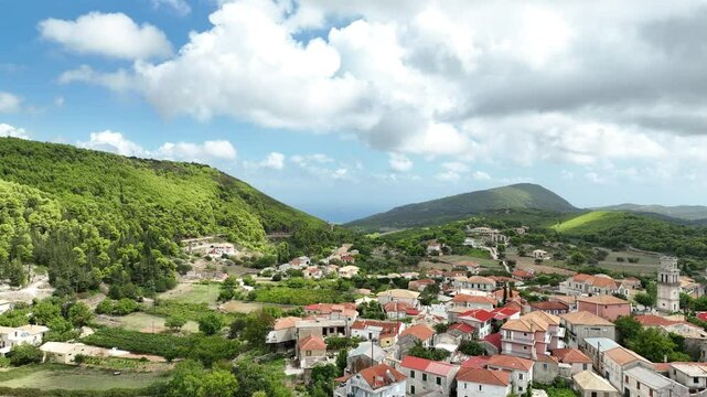 Flying over a town nestled between mountains on the Island of Zakynthos. Mavic 3