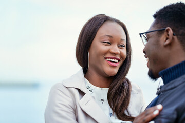 Outdoor, black couple and relationship with love for laugh, vacation holiday and bonding together....
