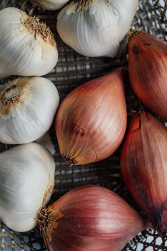 garlic and shallots in basket in kitchen