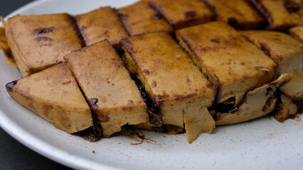 Sweet martabak terang bulan, chocolate peanut pancakes on a white plate