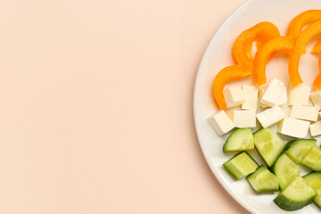 Plate with flag of India made from fresh vegetables and feta cheese on beige background. Indian Independence Day