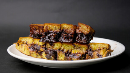 close up of sweet martabak or pancakes with peanuts and melted chocolate inside