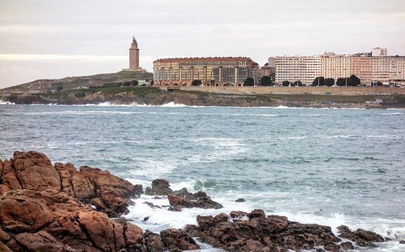 Riazor beach bay in the Spanish city of A Coru&ntilde;a and the Hercules tower lighthouse in the background