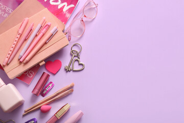 Composition with notebooks, pens, cosmetics and accessories on lilac background