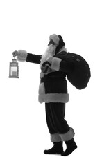 Silhouette of Santa Claus with bag of gifts and lantern on white background
