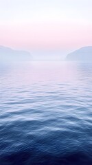Fototapeta premium A tranquil seascape captures the gentle ripples of the water as it mirrors the soft pastel hues of dawn. The serene blue tones create a peaceful ambiance.