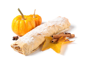Tasty pumpkin strudel with cinnamon, star anise and autumn leaf on white background