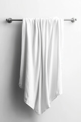 Elegant white towel draped over metal rod, creating minimalist and clean aesthetic. soft fabric adds touch of sophistication to any space