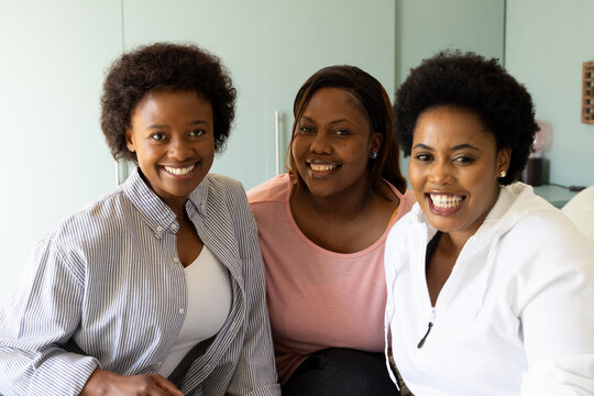 Smiling African american female friends enjoying time together at home, celebrating Thanksgiving