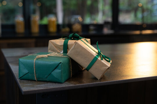 Christmas time, Festive gifts wrapped in green and brown paper on kitchen counter, at home