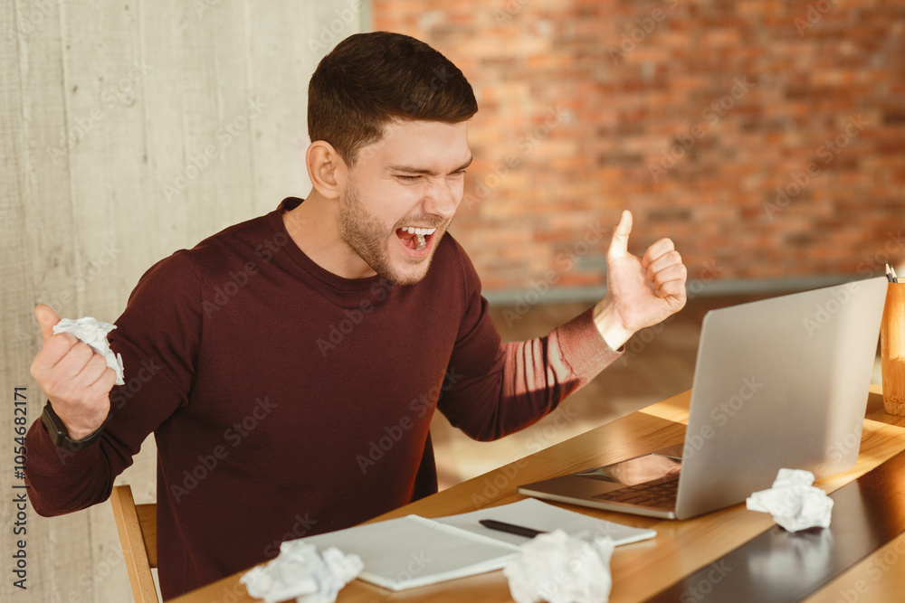 Poster angry overworked freelancer guy shouting crumpling paper sitting at laptop in modern office. selecti