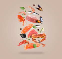 Different sea food in air on dark beige background