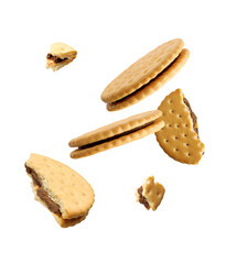 Tasty broken sandwich cookies in air on white background