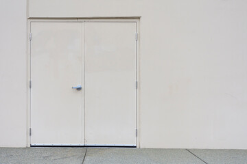 An abstract image of steel exterior double doors on a commercial industrial building. 