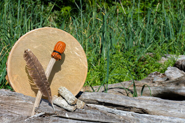 Handmade leather meditation drum with sacred feather and rattle. 