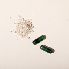 capsules on table with powder