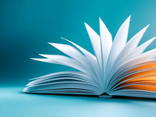 Open book showcasing vibrant pages, ideal for educational and creative themes, on a calming blue background.