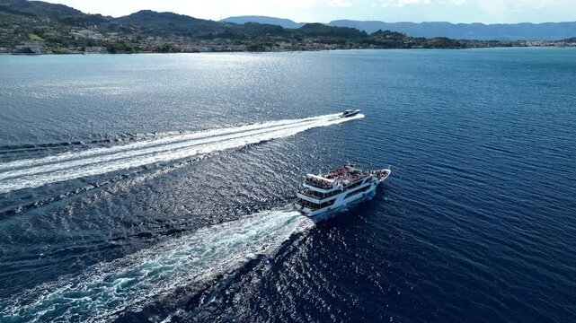 Boat chase near the shore with visible mountain peaks in the Ionian Sea, Greece, Zakynthos Island. Mavic 3
