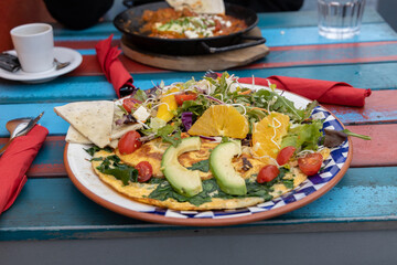 close up of a plate of healthy vegetarian breakfast or brunch with fresh fruit and vegetables