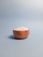 Front view of flour served in a wooden bowl