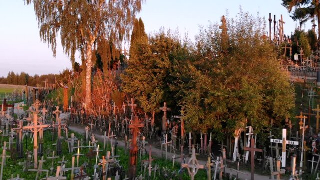 Aerial sunset view of Kryziu kalnas, or the Hill of Crosses, a site of pilgrimage near the city of Siauliai, in northern Lithuania. Sunny summer evening.