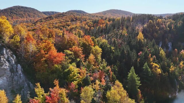 Aerial view of Gypsum Lake in Cape Breton Nova Scotia during Autumn.  Fall foliage of the mountains with multi colored deciduous trees, La Prairie, Cabot Trail, Cape Breton. 