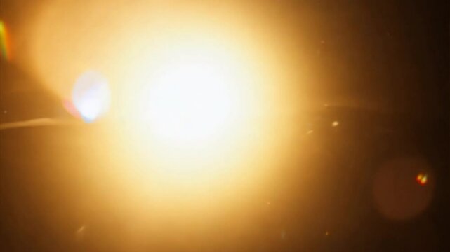 Golden Light Flare: A mesmerizing abstract photo of a bright golden light flare with soft, diffused edges. The light creates a warm and inviting aura.