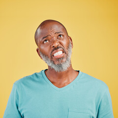 Obraz premium Thinking, frustrated and mature black man in studio with memory, problem solving or decision. Remember, doubt and confused person with brainstorming, ideas and planning choice on yellow background