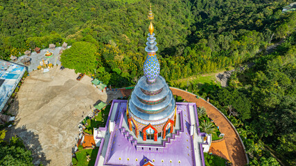 Aerial view of a colourful pagoda overlooking a green valley. pagoda at Wat Thaton on the banks of the Kok River in Chiang Mai Province near the border with Burma..fantastic pagoda of the tribal