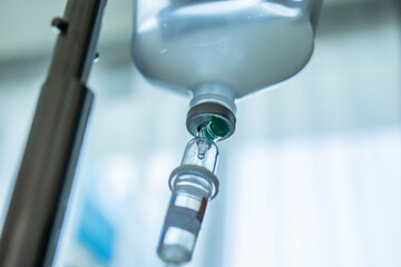 Close up medical intravenous IV drip in hospital background