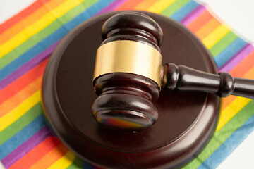 Gavel for judge lawyer on rainbow flag, symbol of LGBT pride month.