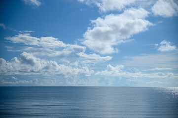 The blue sea with large white clouds in the sky as a background.