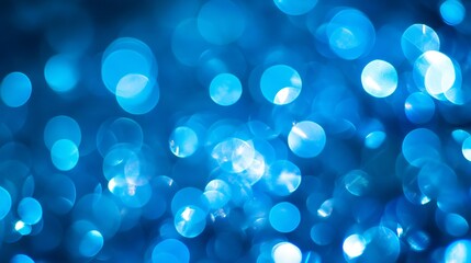 Vibrant blue bokeh background with soft blurred light circles and sparkling effects for photography, web design, and creative projects