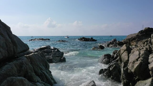 Aerial view of sea and rocky beach in Marinella Di Zambrone on a sunny summer day in Calabria, Italy