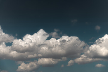 White cumulus clouds close-up, blue sky, big fluffy cloud. Feels like clouds over the sea, low and big