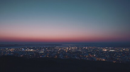 Fototapeta premium Panoramic shot of Reykjavik skyline at dusk, with city lights twinkling and the vast North Atlantic Ocean stretching into the distance. No people included.