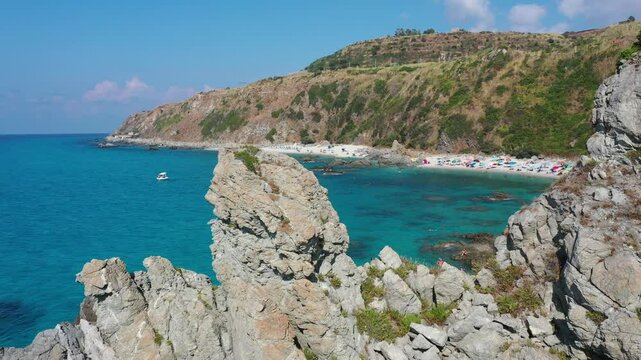 Aerial view of sea and rocky beach in Marinella Di Zambrone on a sunny summer day in Calabria, Italy
