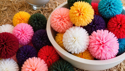 Bowl of colorful pom-poms in various shades on straw background