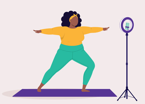 One Overweight Black Woman In Activewear Live Streaming Workout Using Handphone And Ring Light.