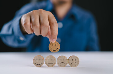 Wooden label with happy normal and sad face icons for experience survey services and products...