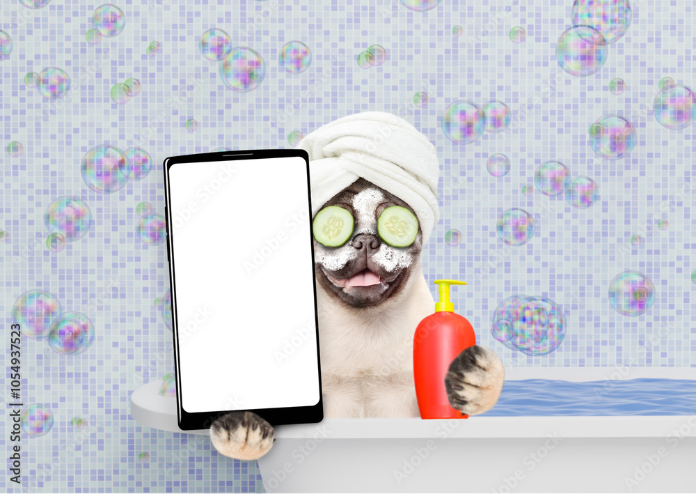 Aufkleber Happy Pug puppy with towel on it head, with cream on it face and with slices of cucumber in it eyes takes the bath and shows big smartphone with white blank screen in it paw. Empty space for text