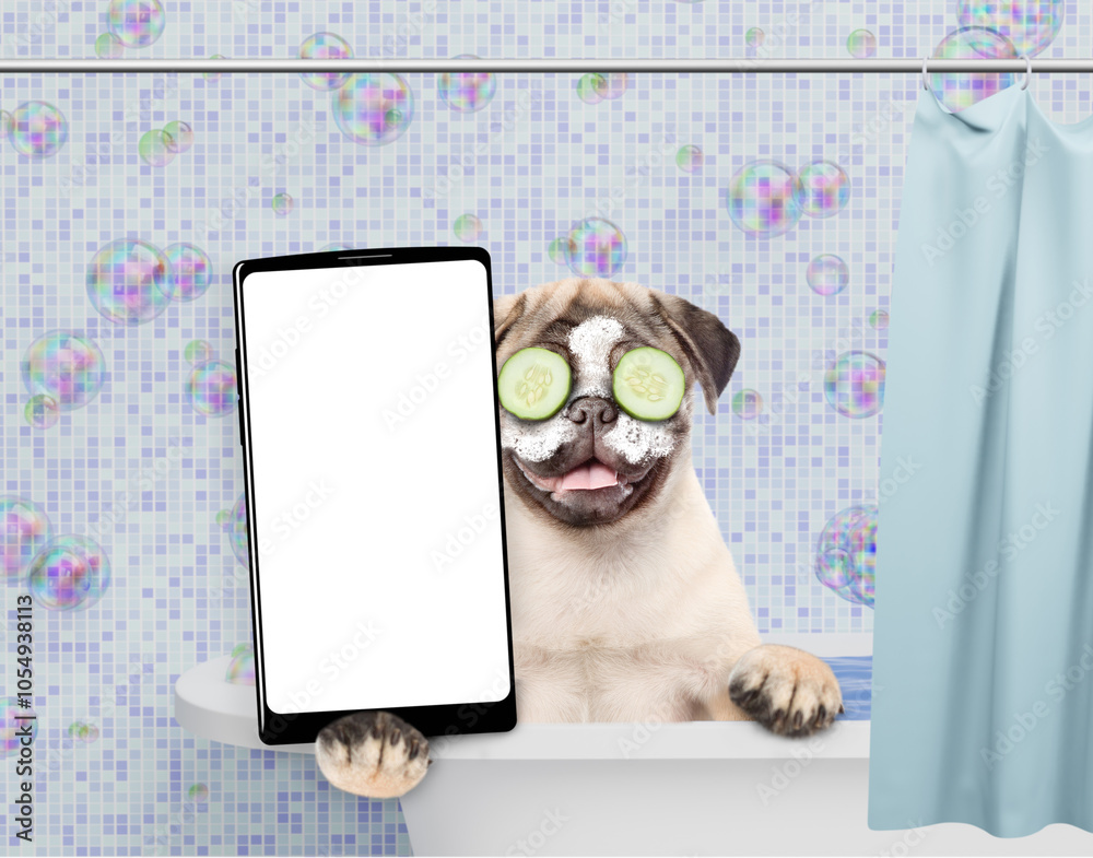 Aufkleber Happy Pug puppy with cream on it face and with slices of cucumber in it eyes takes the bath and shows big smartphone with white blank screen in it paw. Empty space for text