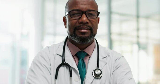 Black man, face and mature doctor with arms crossed in hospital for healthcare, service and ambition. Happy, worker and portrait of male person with smile at clinic for medical, confidence and pride