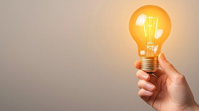 Illuminating ideas a hand holding a bright light bulb symbolizing innovation and creativity in modern thinking