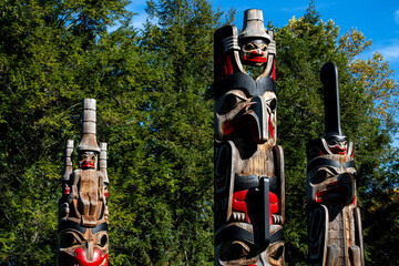 Three totem poles in the forest