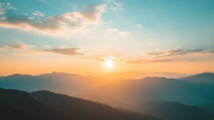 Stunning sunset view over rolling mountains with rocky outcrops and lush grasslands at dusk in a serene landscape