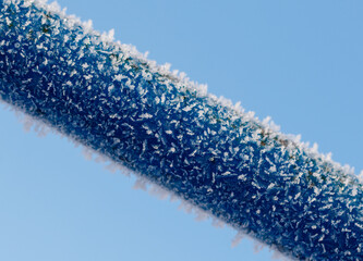 A blue pipe covered in ice