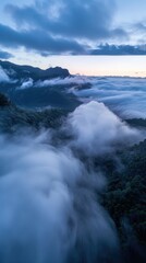 Obraz premium Misty Mountain Majesty: Aerial View of Swirling Morning Fog During Blue Hour 