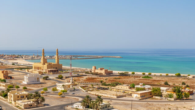scenic landscape of bukha, a coastal town in Musandam, Oman, with a mosque and turquoise sea